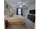 Spacious bedroom features cozy carpet flooring, ceiling fan, and a large window providing plenty of natural light at 13707 Newbridge St, Spring Hill, FL 34609