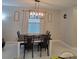 Dining room with an elegant light fixture, a wooden table, and stylish decor at 13707 Newbridge St, Spring Hill, FL 34609