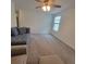 Living room featuring neutral-toned furniture and a ceiling fan at 13707 Newbridge St, Spring Hill, FL 34609