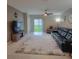 Comfortable living room with a rug, leather sofa, entertainment center, and sliding glass doors at 13707 Newbridge St, Spring Hill, FL 34609
