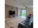 Comfortable living room with a large rug, leather sofa, entertainment center, and sliding glass doors at 13707 Newbridge St, Spring Hill, FL 34609