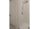 Walk-in shower features sleek, white tiling at 13707 Newbridge St, Spring Hill, FL 34609