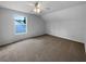 Attic bedroom featuring neutral walls, carpet flooring, and natural light from a window at 16006 Stags Leap Dr, Lutz, FL 33559