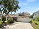 Charming one-story home with dormer windows, two-car garage, and well-manicured lawn at 16006 Stags Leap Dr, Lutz, FL 33559
