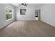 Spacious living room with lots of light, neutral carpet, and view to the outdoor space at 16006 Stags Leap Dr, Lutz, FL 33559