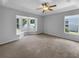 Spacious main bedroom features lots of light from several windows and a ceiling fan at 16006 Stags Leap Dr, Lutz, FL 33559