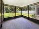 Enclosed patio with concrete floor and screens overlooking fenced-in backyard at 16006 Stags Leap Dr, Lutz, FL 33559