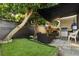 A backyard featuring a grassy area, a shady tree, and an outdoor kitchen setup, ideal for entertaining at 1716 Westerly Dr, Brandon, FL 33511