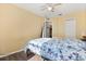Bright bedroom with yellow walls, wood floors, and ceiling fan at 1716 Westerly Dr, Brandon, FL 33511