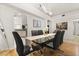 Spacious dining area featuring a glass table, seating for six, contemporary lighting, and an open-concept design at 1716 Westerly Dr, Brandon, FL 33511