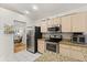Modern kitchen with stainless steel appliances and light wood cabinets at 1716 Westerly Dr, Brandon, FL 33511