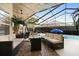 Screened lanai with comfortable seating area and a view of the pool at 1716 Westerly Dr, Brandon, FL 33511