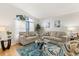 Bright living room featuring vaulted ceilings, plush seating, large window with sheer curtains, and neutral decor at 1716 Westerly Dr, Brandon, FL 33511