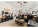 Spacious living area featuring a leather sectional sofa, stylish shelving, an open layout, and modern decor at 1716 Westerly Dr, Brandon, FL 33511