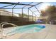 A beautiful screened in pool area, with inviting blue water and a ladder to get in and out at 1716 Westerly Dr, Brandon, FL 33511