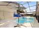 A beautiful screened in pool area, with an umbrella for shade, and inviting blue water for relaxing at 1716 Westerly Dr, Brandon, FL 33511