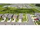 A high aerial shot shows the home's position within a neighborhood, near a green space at 9937 Aqua Miles Path, Wesley Chapel, FL 33545