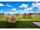 Well-maintained backyard includes a dining set and a play structure at 9937 Aqua Miles Path, Wesley Chapel, FL 33545