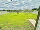 Backyard with manicured green lawn and mature tree, perfect for outdoor enjoyment at 9937 Aqua Miles Path, Wesley Chapel, FL 33545