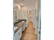 Bathroom featuring double sinks with granite countertops, walk-in closet, and a walk-in shower at 9937 Aqua Miles Path, Wesley Chapel, FL 33545