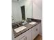Bathroom featuring a double vanity with a granite countertop and modern fixtures at 9937 Aqua Miles Path, Wesley Chapel, FL 33545