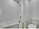 Bright bathroom with white subway tile, and bathtub with shower at 9937 Aqua Miles Path, Wesley Chapel, FL 33545