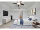 Modern bedroom with TV, decor, and minimalist furniture at 9937 Aqua Miles Path, Wesley Chapel, FL 33545