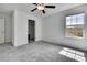 Bright bedroom with gray carpet, window, and closet, offering a serene retreat for rest and relaxation at 9937 Aqua Miles Path, Wesley Chapel, FL 33545