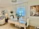 Elegant dining room showcasing a modern chandelier, neutral decor, and bright natural light at 9937 Aqua Miles Path, Wesley Chapel, FL 33545