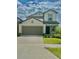 Charming two-story home features a well-manicured lawn, inviting entrance, and attached two-car garage at 9937 Aqua Miles Path, Wesley Chapel, FL 33545