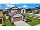 Beautiful two-story home with a two car garage and manicured lawn with lush landscaping at 9937 Aqua Miles Path, Wesley Chapel, FL 33545
