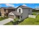 A side angled shot of the property shows the manicured lawn, side yard, and exterior paint colors at 9937 Aqua Miles Path, Wesley Chapel, FL 33545