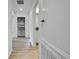Bright hallway features wood-look floors, a linen closet, and doorways to various rooms at 9937 Aqua Miles Path, Wesley Chapel, FL 33545