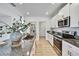 Modern kitchen featuring a granite countertop, stainless steel appliances and sleek, white cabinetry at 9937 Aqua Miles Path, Wesley Chapel, FL 33545