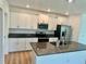Modern kitchen featuring white cabinets, stainless steel appliances, and granite countertops at 9937 Aqua Miles Path, Wesley Chapel, FL 33545