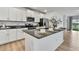 Bright kitchen featuring granite countertops, stainless steel appliances, and sleek white cabinets at 9937 Aqua Miles Path, Wesley Chapel, FL 33545