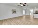 Minimalist living area with wood-style floors and decorative lighting fixtures at 9937 Aqua Miles Path, Wesley Chapel, FL 33545