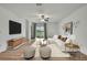 Open-concept living room with lots of seating space and modern decor at 9937 Aqua Miles Path, Wesley Chapel, FL 33545