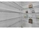 Walk-in pantry featuring wire shelving to maximize storage space for groceries and essentials at 9937 Aqua Miles Path, Wesley Chapel, FL 33545