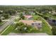 Overhead view of home featuring mature trees, screened pool, landscaping, and lake views at 17032 Winners Cir, Odessa, FL 33556