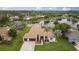 Aerial view of home showcasing tile roof, two car garage, landscaping, and lake view at 17032 Winners Cir, Odessa, FL 33556