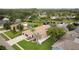 Aerial view of property backing onto a lake, featuring mature landscaping and an outdoor pool area at 17032 Winners Cir, Odessa, FL 33556