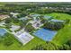 Bird's eye view featuring community sports courts and tennis courts surrounded by well-manicured landscaping at 17032 Winners Cir, Odessa, FL 33556