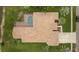 Aerial view of home showcasing the unique roof style and screened pool at 17032 Winners Cir, Odessa, FL 33556