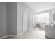 Bright bathroom with double vanity sinks, soaking tub, and tile flooring at 17032 Winners Cir, Odessa, FL 33556