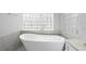 Freestanding soaking tub adjacent to window block at 17032 Winners Cir, Odessa, FL 33556