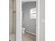 Cozy bathroom with a toilet, shower and window at 17032 Winners Cir, Odessa, FL 33556
