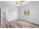 Cozy bedroom featuring wood floors, a ceiling fan, and a bright window at 17032 Winners Cir, Odessa, FL 33556