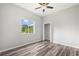 Bedroom showcasing wood floors, a large window and a closet with ample storage space at 17032 Winners Cir, Odessa, FL 33556
