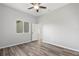 Bedroom features laminate flooring, neutral walls, a ceiling fan and a window for natural light at 17032 Winners Cir, Odessa, FL 33556